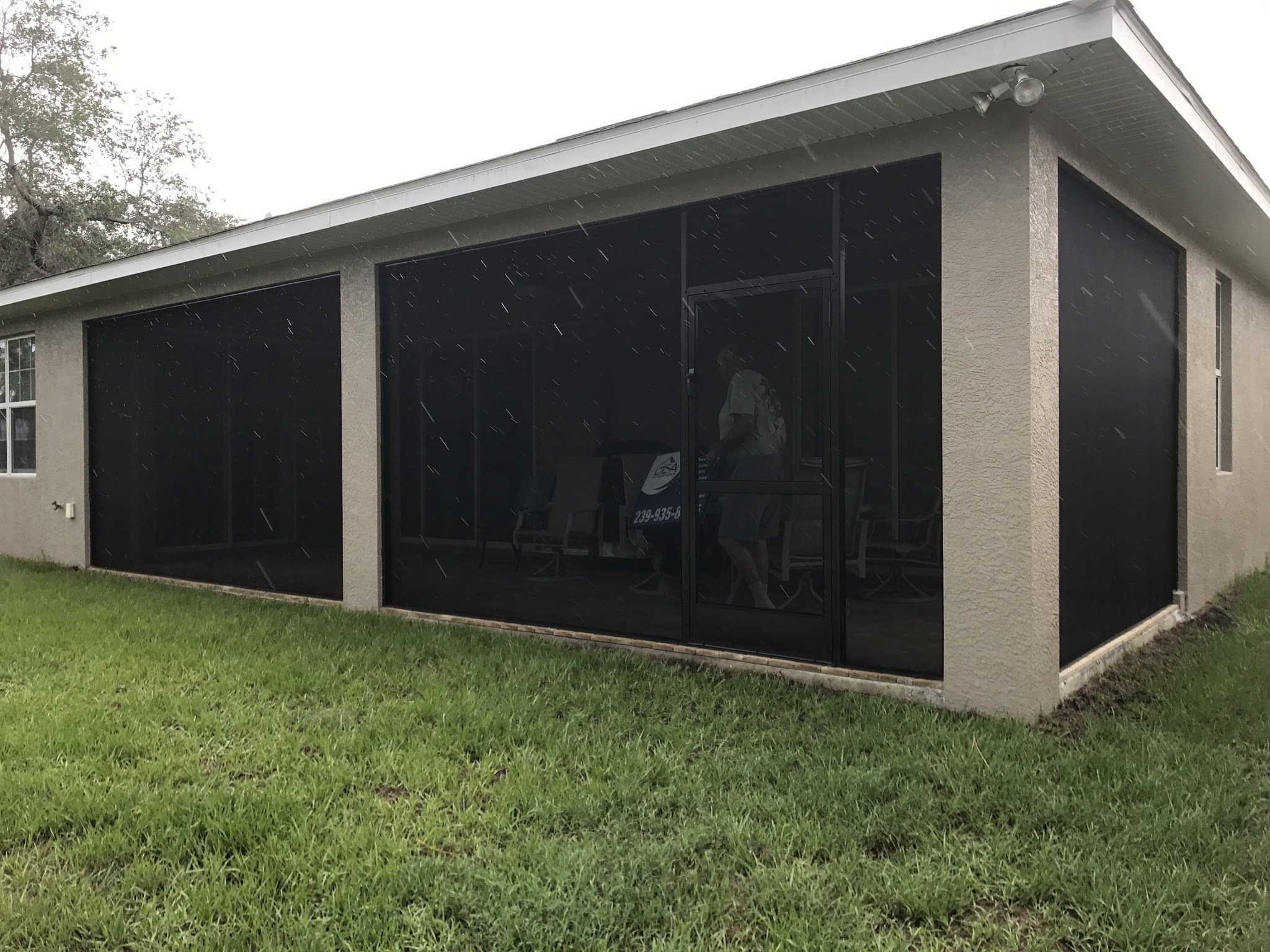 A screen enclosure under truss of masonry house in Florida.